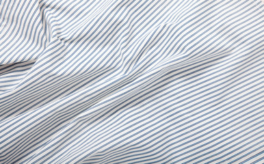 White and blue striped fabric texture with creased folds