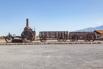 old steam tractor and wagons serving the mine road in the death valley for Borate mining