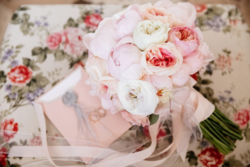 Bride's flowers  and rings on a chair