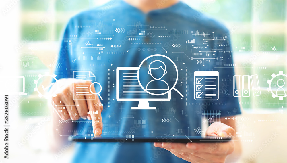 Poster document management system concept with young man using a tablet computer