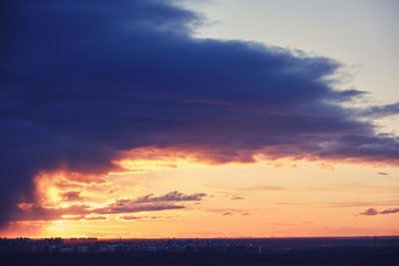 Clouds over the city during the orange sunset