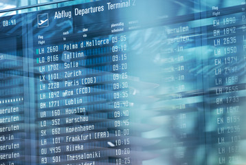 Flights information on modern departures board in airport terminal.