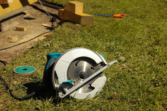 Circular saw with a round disk plugged into an electricity source. Handy circular saw.