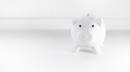 Savings concept. Piggy bank, white with copy space, isolated on white background, banner.