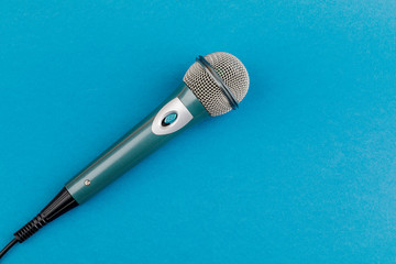 Vocal audio microphone on a blue background.