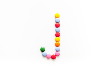 Candies font alphabet. Letter J isolated top view