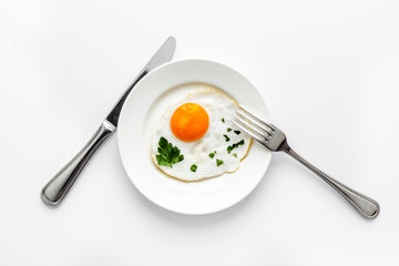 Fried eggs on plate - white kitchen table top view