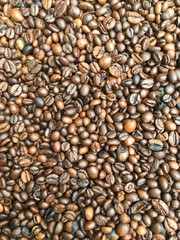 large roasted coffee grains, background texture from coffee beans
