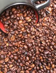 full bowl of roasted large coffee beans, coffee beans texture background