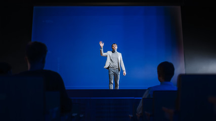 Successful Speaker Stands on Stage and Does New Product Presentation. Presenter / Motivational...