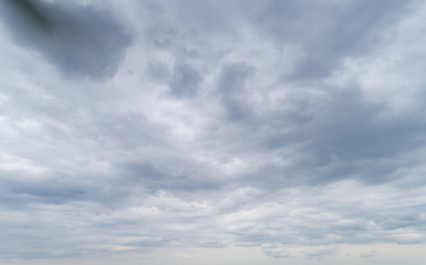 Cloudy gray sky with thick dense clouds.