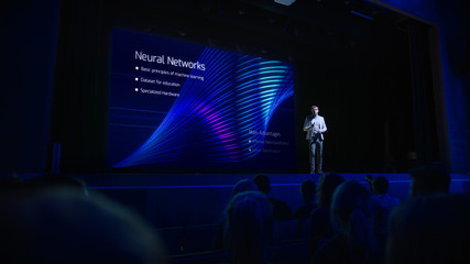 Computer Science Startup Conference: On Stage Speaker Does Presentation of New Product, Talks about...