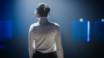 Female Motivational Speaker on Stage, Talking about Happiness, Diversity, Success, Leadership, STEM and How to Be Productive. Woman Presenter Leads Tech Business Conference. Back View Shot