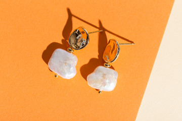 Women's Jewelry. Trendy jewelry on coloured background. Flat lay, top view.