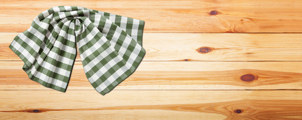 Empty wooden deck table with napkin tablecloth