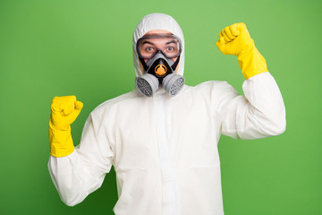 Close-up portrait of his he nice professional disinfectant wearing gas mask rubber gloves celebrating having fun decontamination good news isolated over green pastel color background