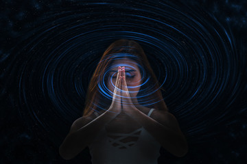 Young woman meditation by folding hands together connect to universe energy , mind and body healing.