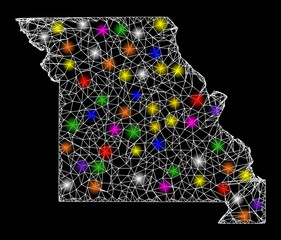 Web mesh vector map of Missouri State with glare effect on a black background. Abstract lines, light spots and spheric points form map of Missouri State constellation.
