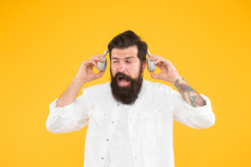 Hearing problem. Bearded man headphones. Active Noise Cancellation Technology. Hipster listen music stereo headphones. Modern wireless headphones. Dance music tracks. Ears health. Loud music - obrazy, fototapety, plakaty
