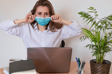 Woman in quarantine for Coronavirus wearing protective mask and smart working