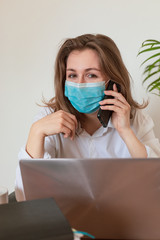 Woman in quarantine for Coronavirus wearing protective mask and smart working