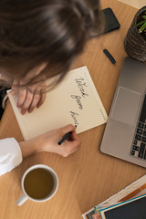 Woman working on laptop at home office while drinling coffee. Web conection