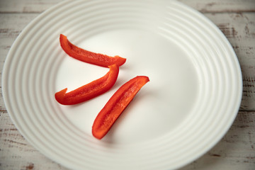 Bulgarian red pepper slices on white plate