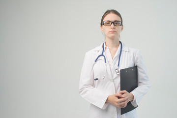 Portrait of an attractive young female doctor in white coat.