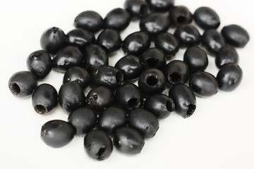 Delicious black olives on a white plate 