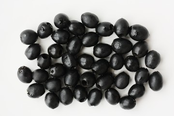 Delicious black olives on a white plate 