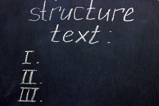 The words "text structure" and paragraph numbers written on a dark board. The challenge for a freelancer - copywriter