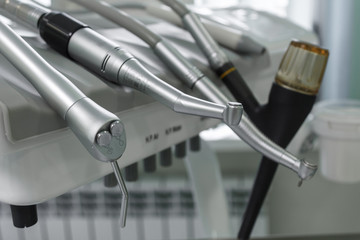 Dental handpiece. Equipment and dental instruments in dentist's office. Tools close-up. Dentistry. Stomatological tools. Shallow depth of field.