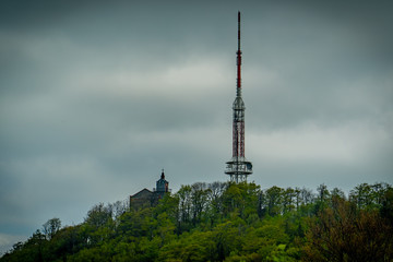 Church and transmission tower on the top of a forested peak.