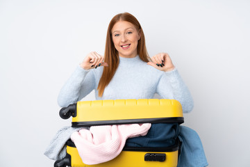 Traveler woman with a suitcase full of clothes proud and self-satisfied