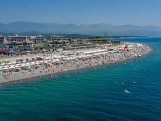 Sea, people on the beach, aerial view. Summer vacation in Sochi.