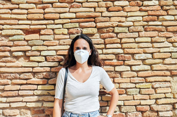 Woman with antiviral mask outdoors