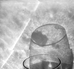 Cropped Image Of Glass With Shadow On Wall