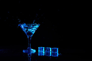 Martini cocktail drink splash with ice cubes in neon iridescent . Minimal night party life concept.