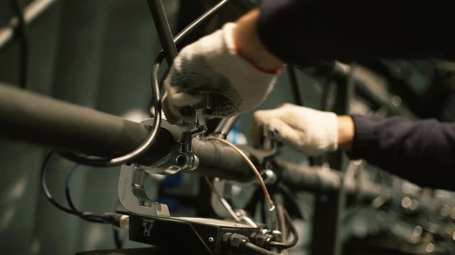 the worker installs spotlights behind the scenes hands screws