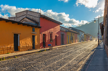 City life at sunrise in the colorful colonial style streets of Antigua, Guatemala.
