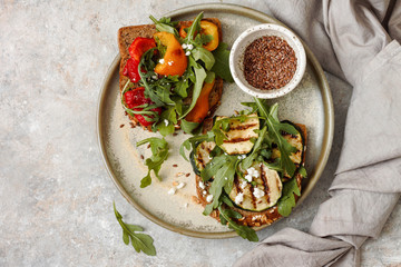 Healthy sandwich with arugula, grilled vegetables and feta

