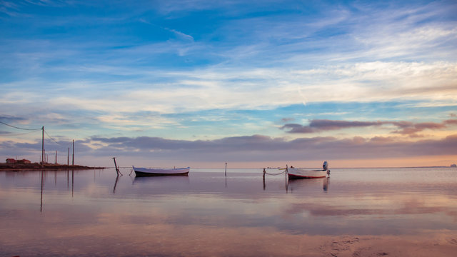 small fishing boats on the pond of Ayrolle near Gruissan at sunset.