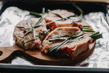 three pieces of lard seasoned with spices and greens for roasting pork