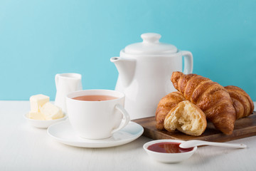 Fresh delicious breakfast with hot tea and  croissants