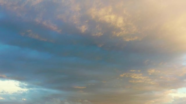 Low clouds drift across the tranquil sky at sunset. All clouds are made up of water droplets or ice crystals that float in the sky.