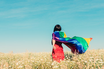 woman with lgbt flag on the field