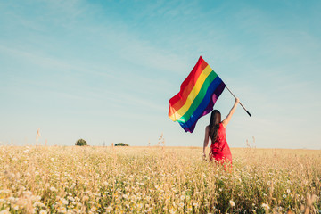 woman with lgbt flag on the field
