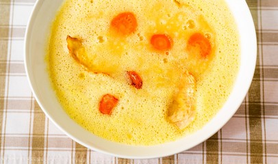 Vegetable soup from celery and carrot on plate, closeup.