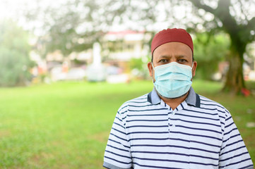 Senior Asian Muslim Man in medical mask, looking at camera Health care and medical concept.