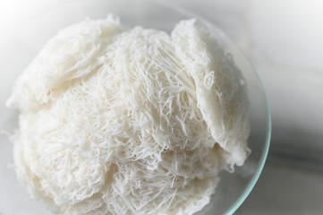 Idiyappam or string hoppers is a popular traditional breakfast cuisine of Kerala, South India. Rice flour pressed into white noodle form and then steamed.